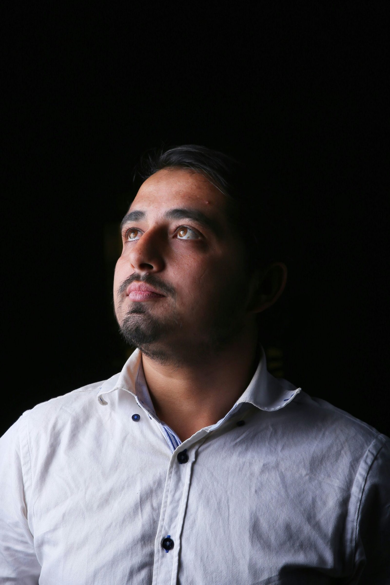 a man in a white shirt looking up